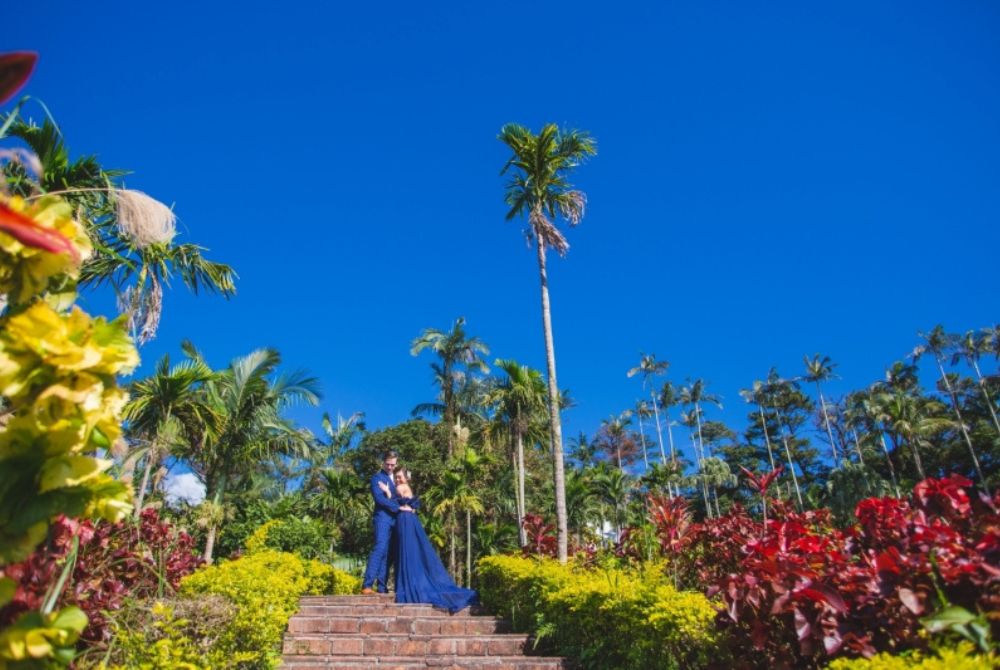東南植物楽園でブルータキシードとドレスに身を包んだカップル